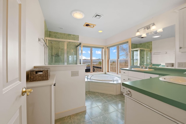 full bath featuring vanity, a bath, a stall shower, and tile patterned floors