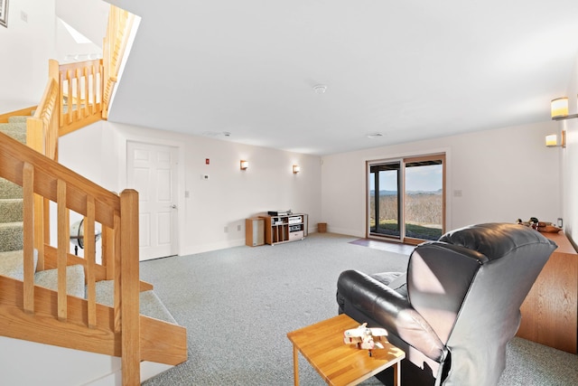 living room with carpet flooring, baseboards, and stairway