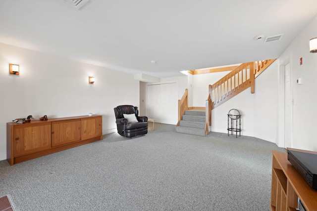 sitting room featuring visible vents, carpet flooring, and stairs