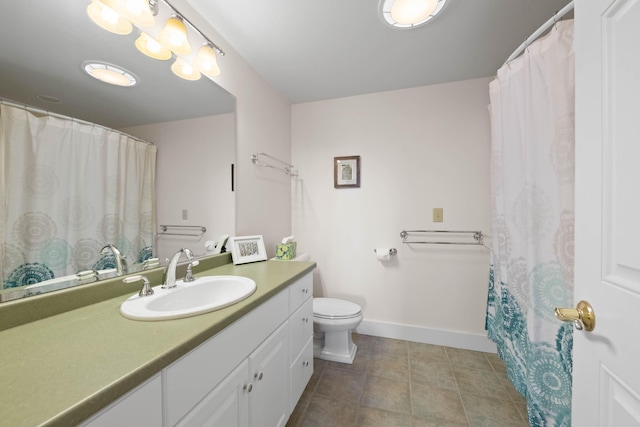 bathroom with toilet, baseboards, tile patterned floors, and vanity