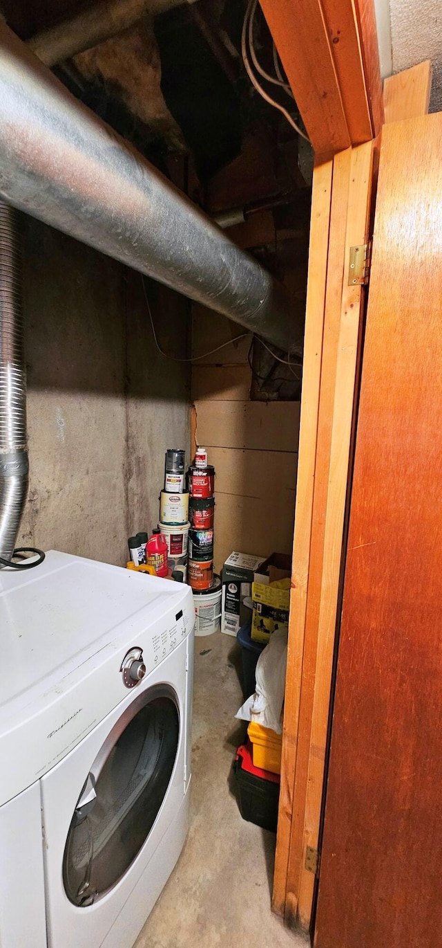 clothes washing area featuring washer / dryer and laundry area