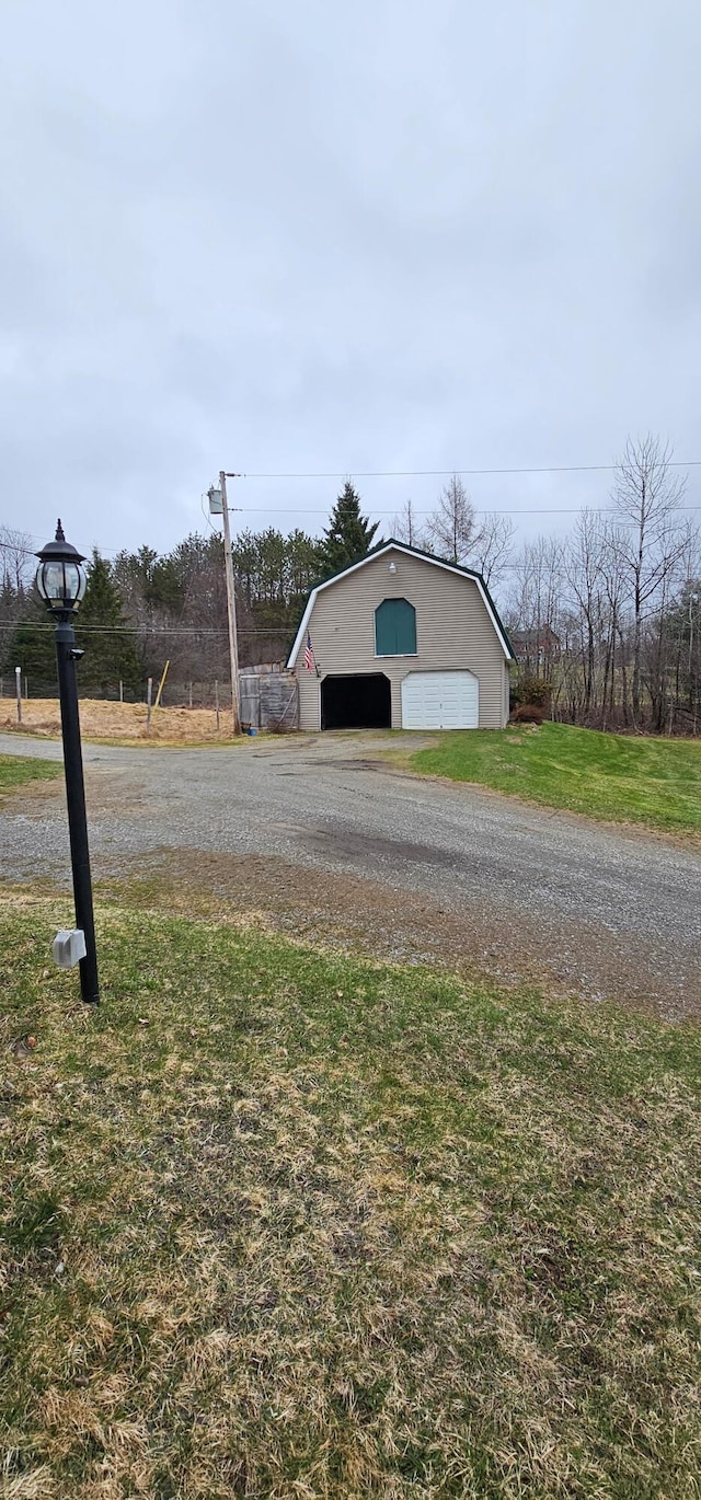 exterior space with an outdoor structure and a detached garage