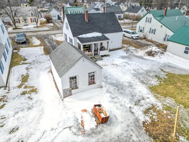 snowy aerial view with a residential view