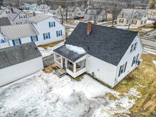 snowy aerial view featuring a residential view