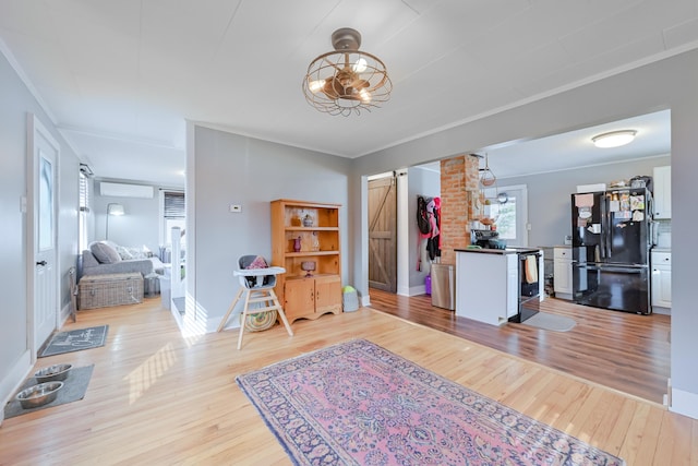 foyer featuring light wood-type flooring, baseboards, and crown molding