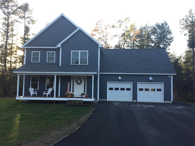 view of front of house with a front lawn, aphalt driveway, a porch, roof with shingles, and an attached garage