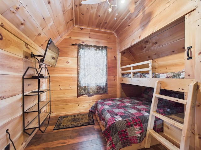 bedroom featuring wood ceiling, wood walls, vaulted ceiling, and hardwood / wood-style flooring