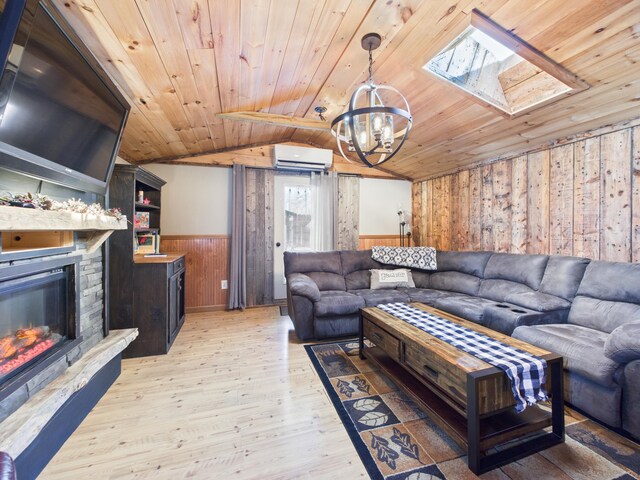 living room with lofted ceiling with skylight, a wainscoted wall, a wall mounted air conditioner, light wood-type flooring, and wooden ceiling