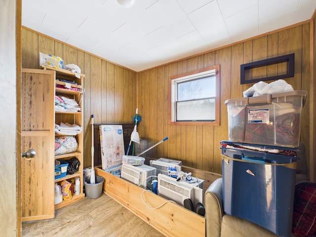 interior space with wood finished floors and wood walls