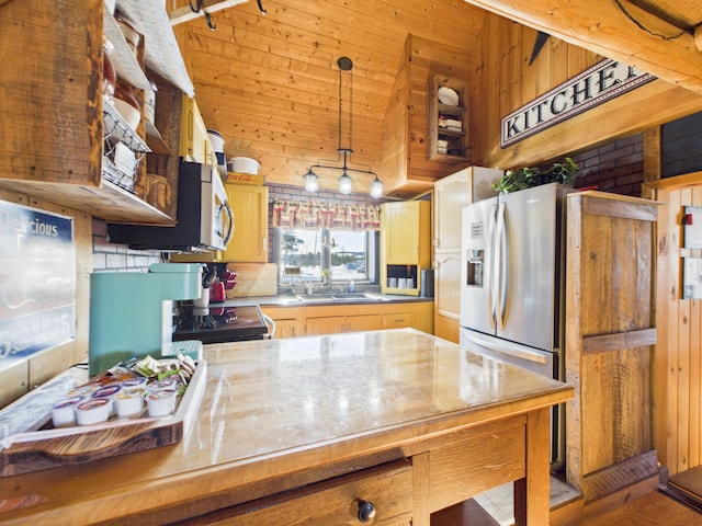 kitchen featuring hanging light fixtures, high vaulted ceiling, wood walls, and stainless steel appliances