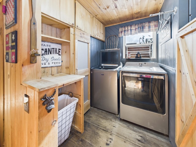 clothes washing area with wooden walls, laundry area, wooden ceiling, dark wood-style floors, and washer and dryer