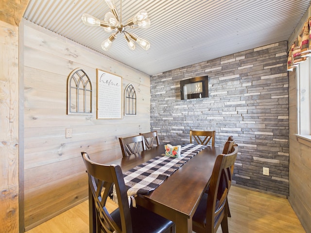 dining space featuring an inviting chandelier and wood finished floors