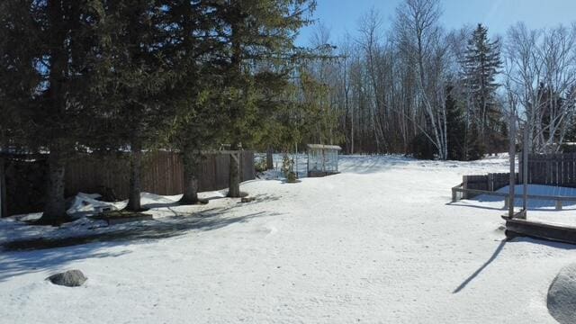 yard covered in snow with fence