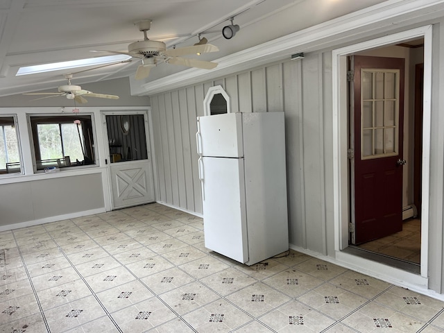 kitchen with freestanding refrigerator, lofted ceiling with beams, and a ceiling fan