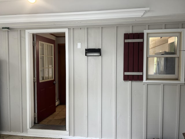 entrance to property featuring a baseboard radiator