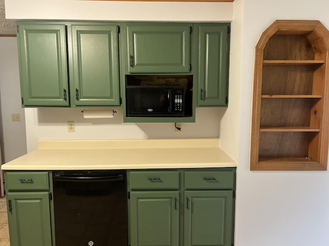 kitchen featuring light countertops, black appliances, and green cabinets