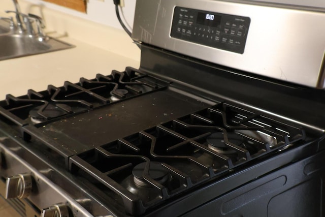 room details with a sink and stainless steel gas stove