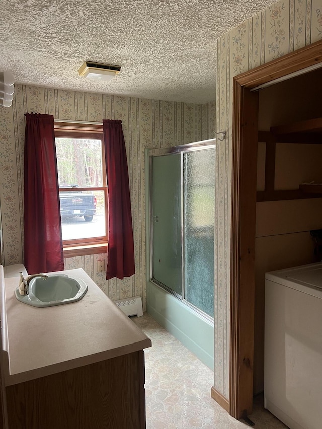 full bath with wallpapered walls, a baseboard radiator, washer / clothes dryer, and a sink