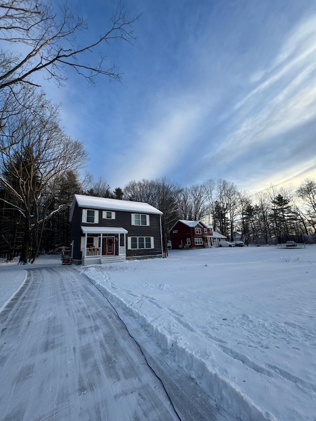 view of front of home with a gambrel roof and covered porch