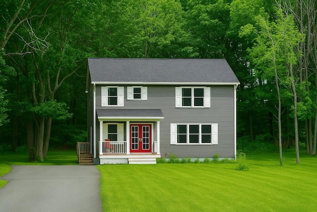 37 Coe St, Auburn, ME 04210 - view of front facade with covered porch, a front lawn, and a shingled roof