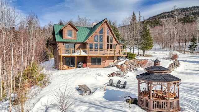 84 Ira Mountain Rd, Kingfield, ME 04947 - snow covered house featuring a balcony, a standing seam roof, metal roof, and a gazebo