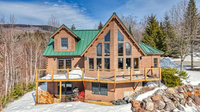 84 Ira Mountain Rd, Kingfield, ME 04947 - snow covered property with a standing seam roof, metal roof, and a deck