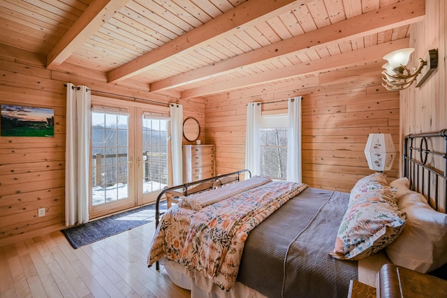 84 Ira Mountain Rd, Kingfield, ME 04947 - bedroom featuring french doors, wooden walls, access to exterior, wood-type flooring, and multiple windows