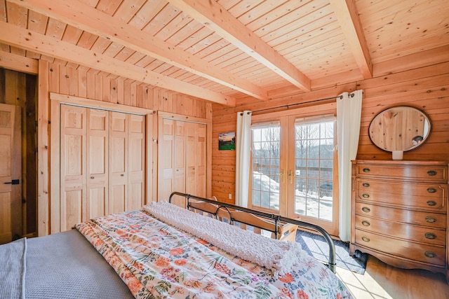 84 Ira Mountain Rd, Kingfield, ME 04947 - bedroom with wooden walls, french doors, multiple closets, wood finished floors, and wood ceiling with exposed beams