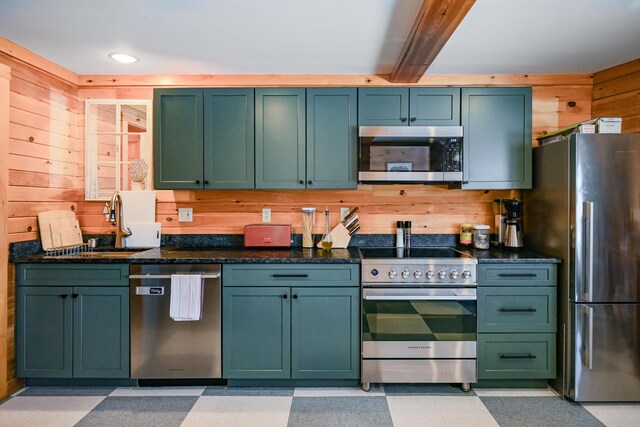 84 Ira Mountain Rd, Kingfield, ME 04947 - kitchen featuring appliances with stainless steel finishes, wood walls, green cabinetry, beamed ceiling, and light flooring