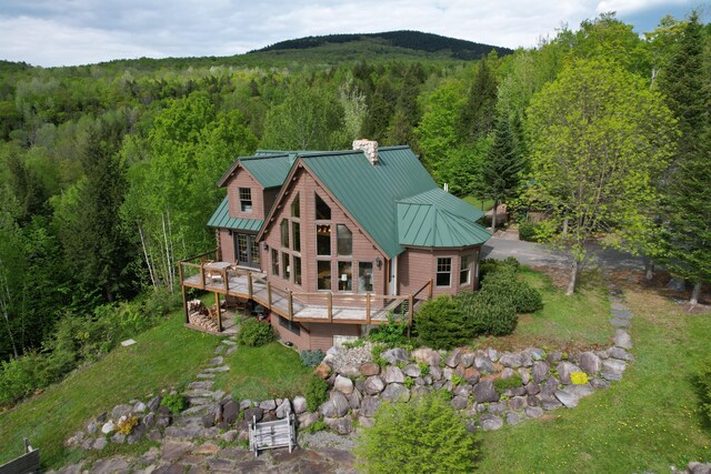 84 Ira Mountain Rd, Kingfield, ME 04947 - rear view of property with a forest view, a chimney, a deck, a standing seam roof, and metal roof