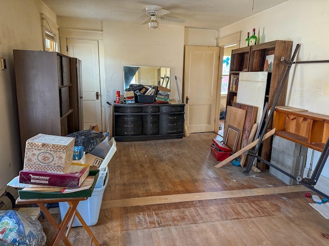 kitchen with ceiling fan, hardwood / wood-style flooring, open shelves, and a textured ceiling