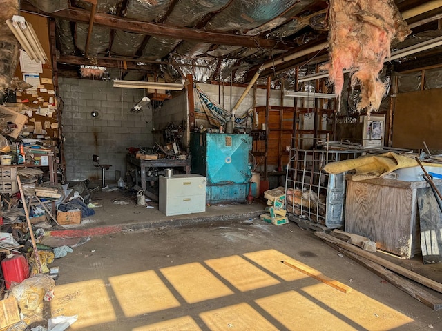 miscellaneous room featuring concrete flooring and concrete block wall