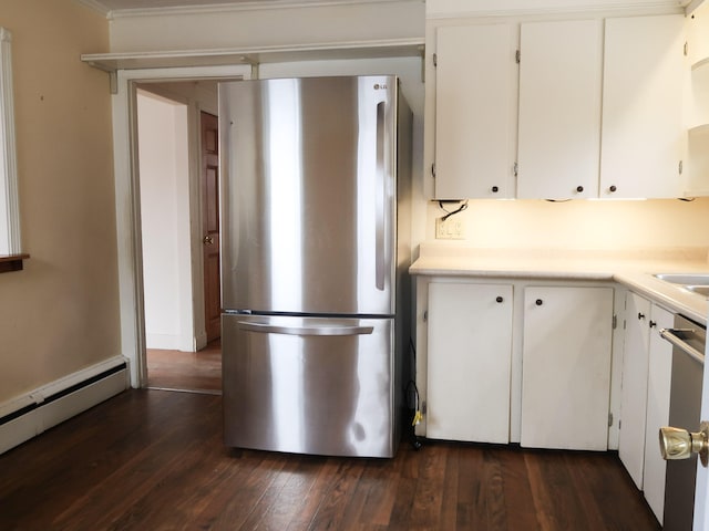 kitchen with dark wood-style floors, white cabinetry, freestanding refrigerator, light countertops, and a baseboard heating unit