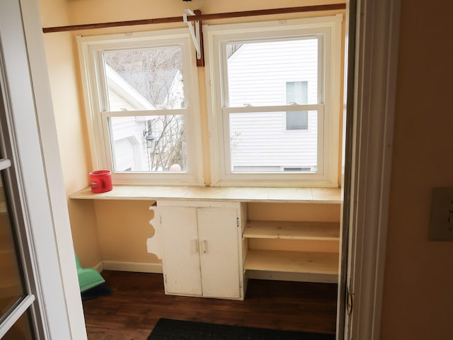 interior space featuring wood finished floors and baseboards