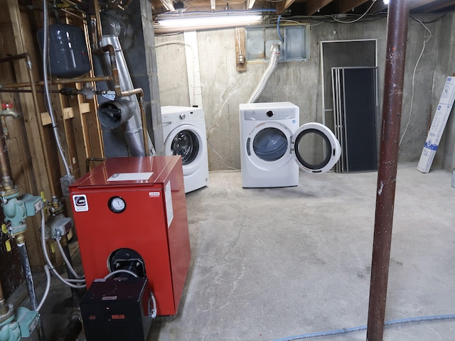 unfinished basement with washer and dryer and a heating unit