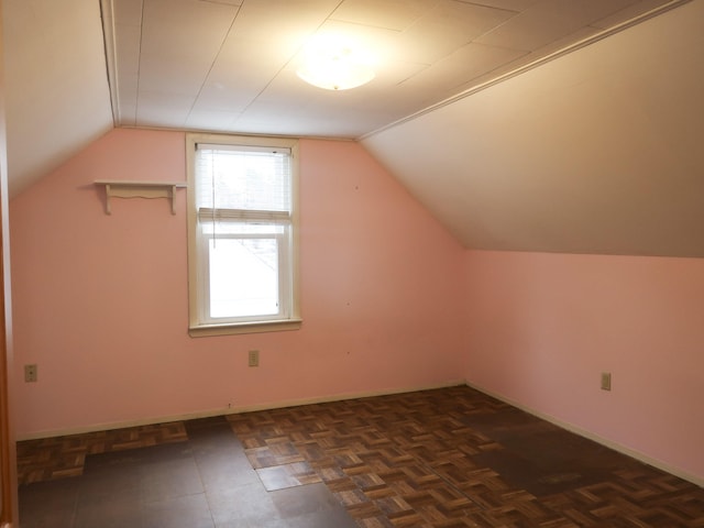 bonus room featuring baseboards and vaulted ceiling