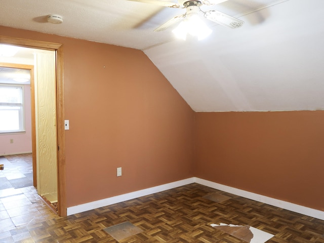 additional living space with a ceiling fan, lofted ceiling, and baseboards