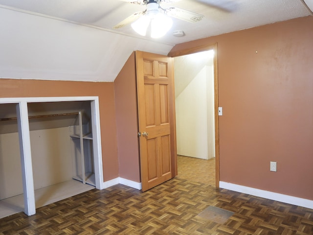 additional living space with vaulted ceiling, baseboards, and ceiling fan