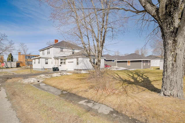 view of front of home featuring a chimney and a front yard