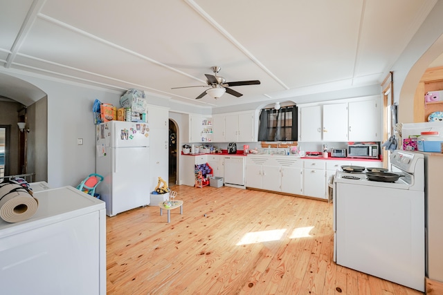 kitchen featuring white appliances, a ceiling fan, light wood finished floors, arched walkways, and white cabinetry