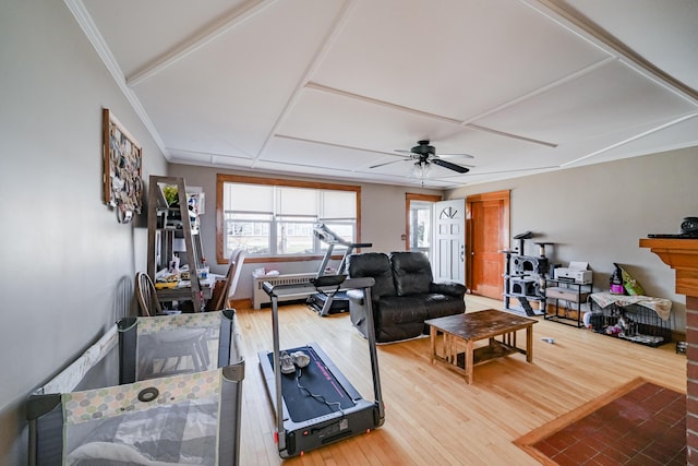 living room with ceiling fan, crown molding, and hardwood / wood-style flooring