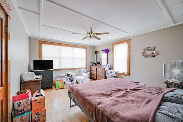 bedroom featuring crown molding, light wood-type flooring, and ceiling fan