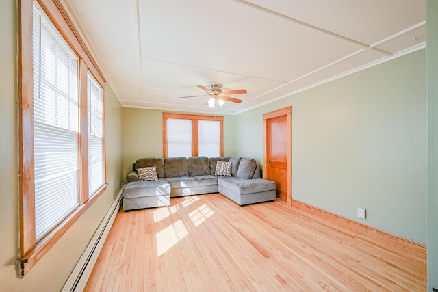 unfurnished living room featuring a ceiling fan, ornamental molding, wood finished floors, and a baseboard radiator