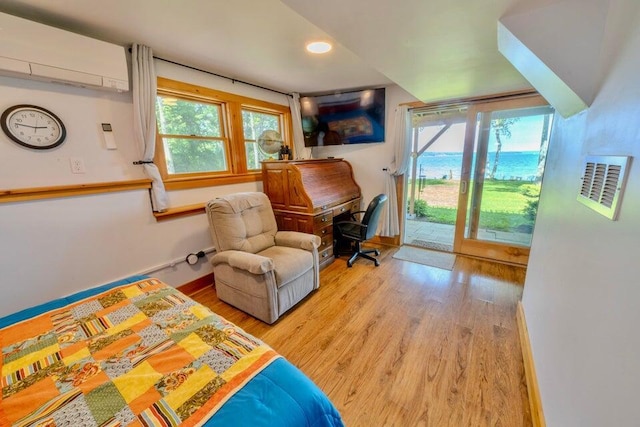 19 Glenview Ln, Belfast, ME 04915 - bedroom with access to exterior, wood finished floors, a wall unit AC, recessed lighting, and an office area