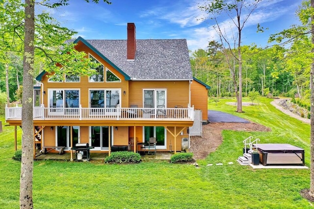19 Glenview Ln, Belfast, ME 04915 - rear view of property with a hot tub, a wooden deck, a chimney, and a yard