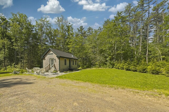 4 Boulder Cove Way, Bremen, ME 04551 - view of green lawn featuring entry steps and a view of trees