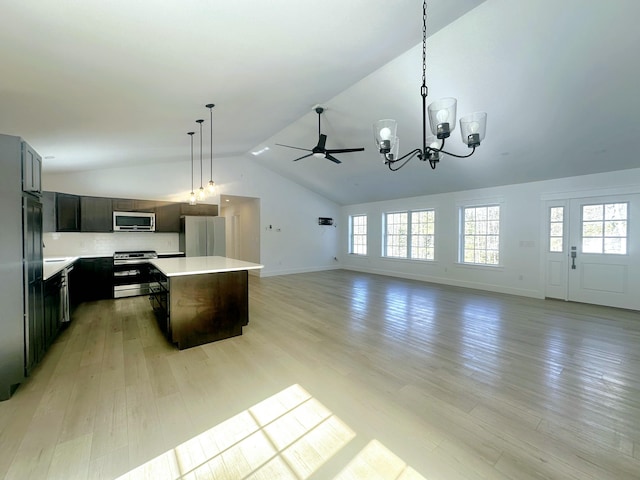 kitchen featuring a center island, appliances with stainless steel finishes, pendant lighting, and light wood-style floors