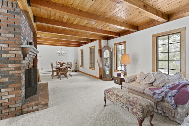 living area with carpet floors, beam ceiling, wooden ceiling, a brick fireplace, and a notable chandelier