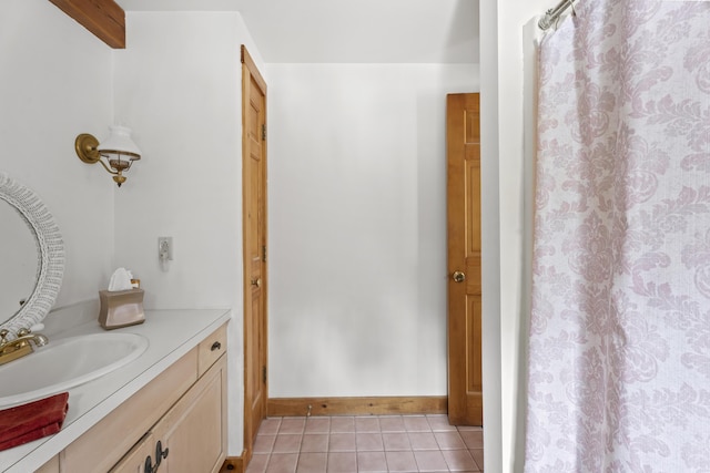 bathroom featuring tile patterned flooring, vanity, and baseboards