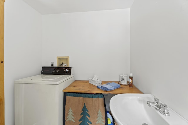 laundry room featuring a sink and washer / clothes dryer